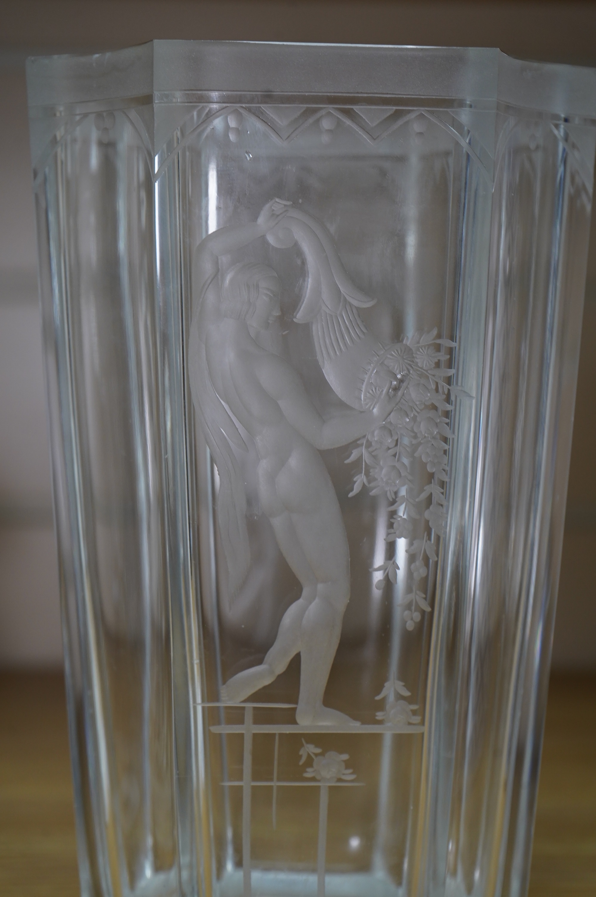 Emil Weidlich for Elme, a 1930s Swedish cut and etched glass vase decorated with a figure tipping a floral cornucopia. Condition - minute chips to two corner tips of the rim otherwise very good, The glass engraver Weidli